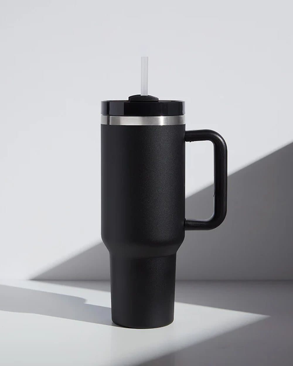 Black travel tumbler with a straw lid